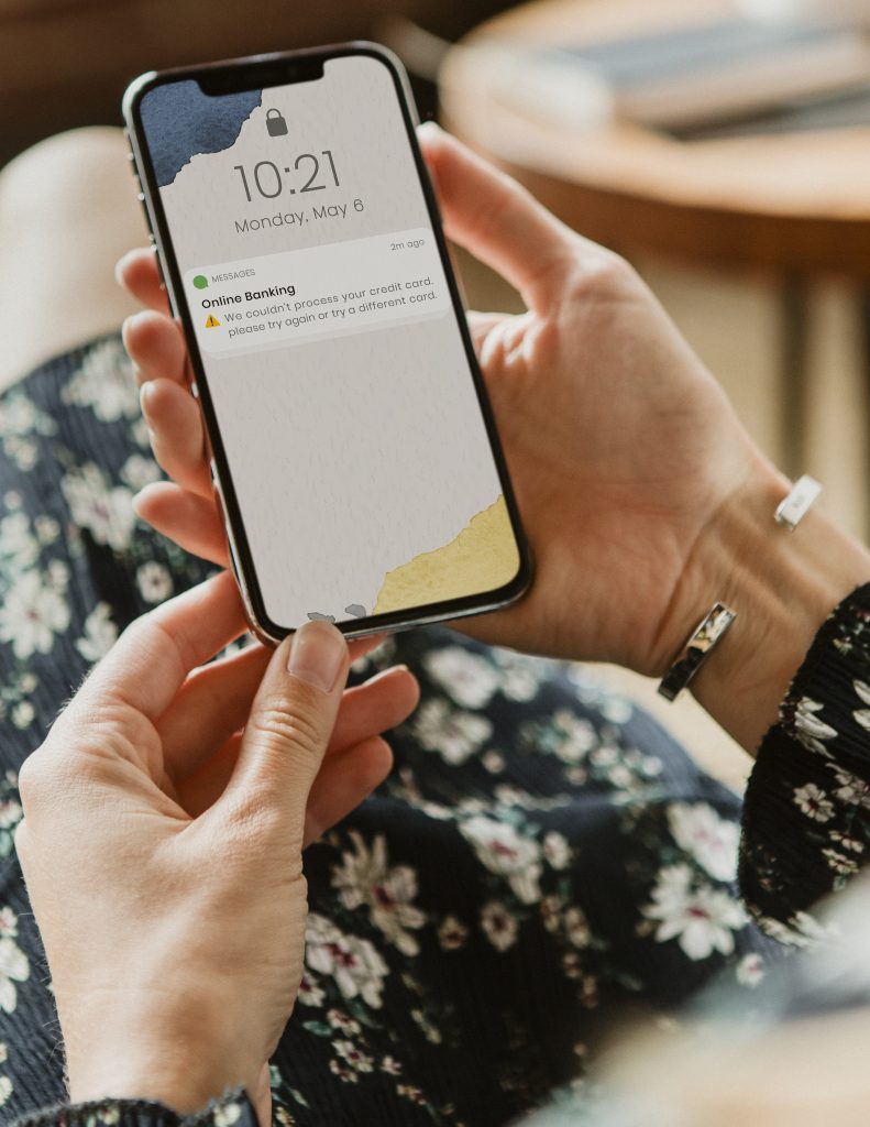 A person is holding a mobile phone showing some apps
