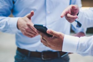 Person with black smartphone in his hand