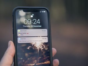 The image shows a mobile phone showing some push notifications
