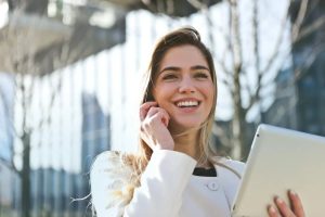 Woman reading news on her laptop feels excited and happy