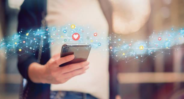 The image shows a person holding a mobile phone in his hand