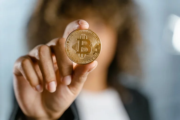 The image shows a woman showing a Bitcoin