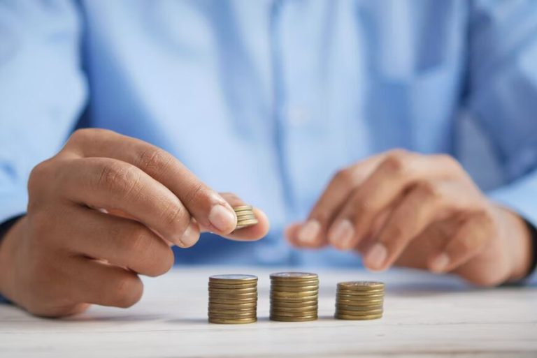 The image shows a person organizing coins on a table